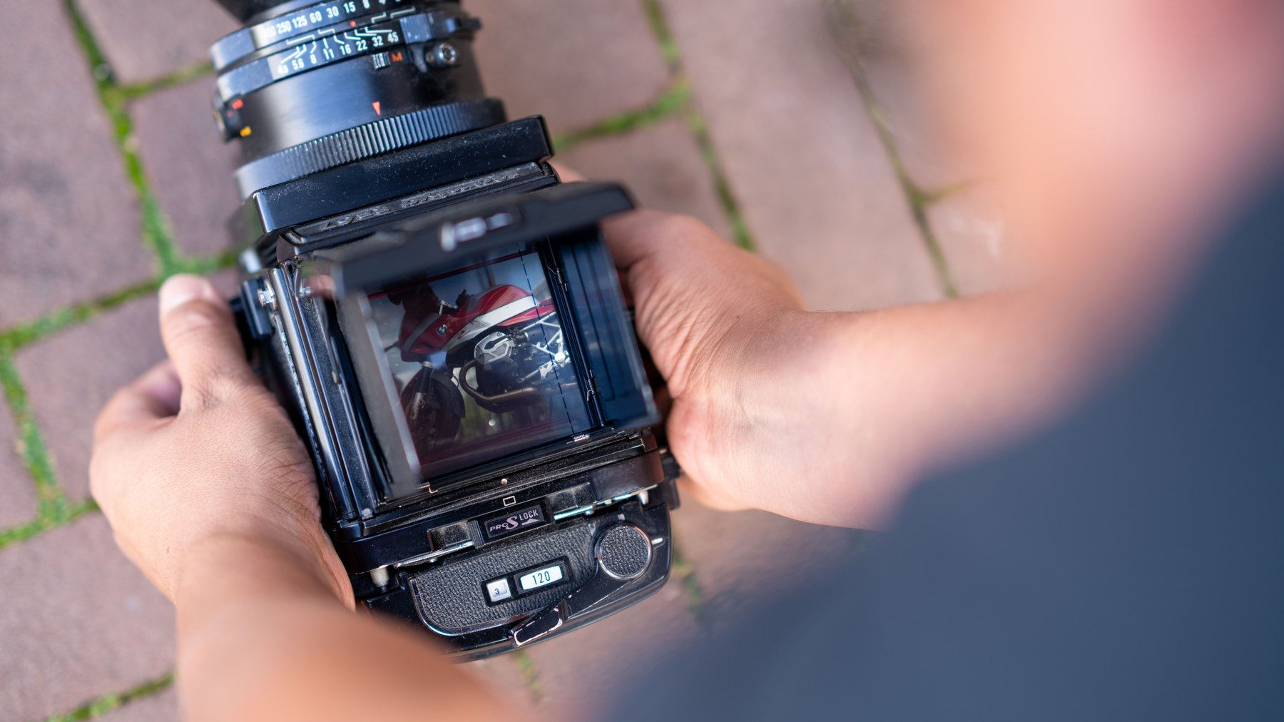 Close-up of a medium-format camera being held during the conversation about analog photography.