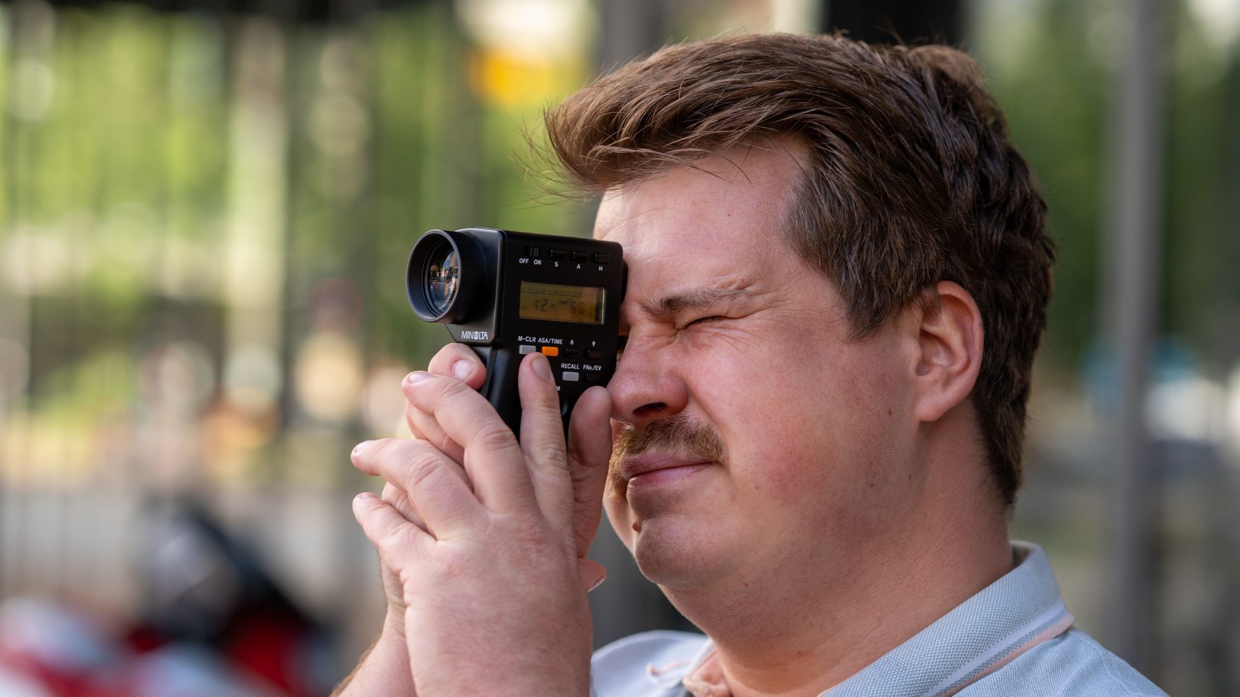 Rik looking through an analog camera during the conversation.