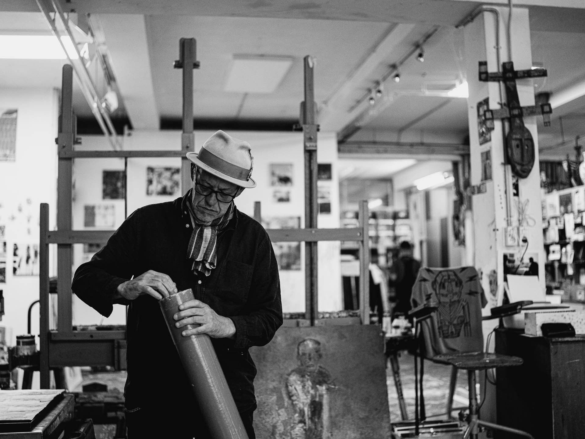 Black-and-white documentary photograph of a maker at work in a studio, photographed by Cas van Laar.