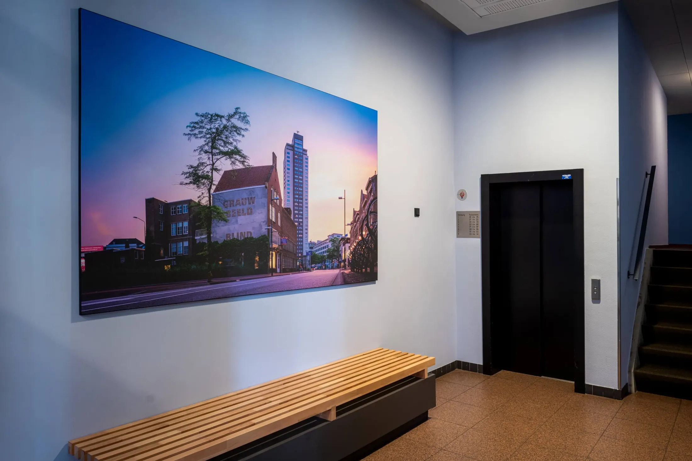Een groot formaat stadsfoto van Jan Timmer aan de wand van een interieur.