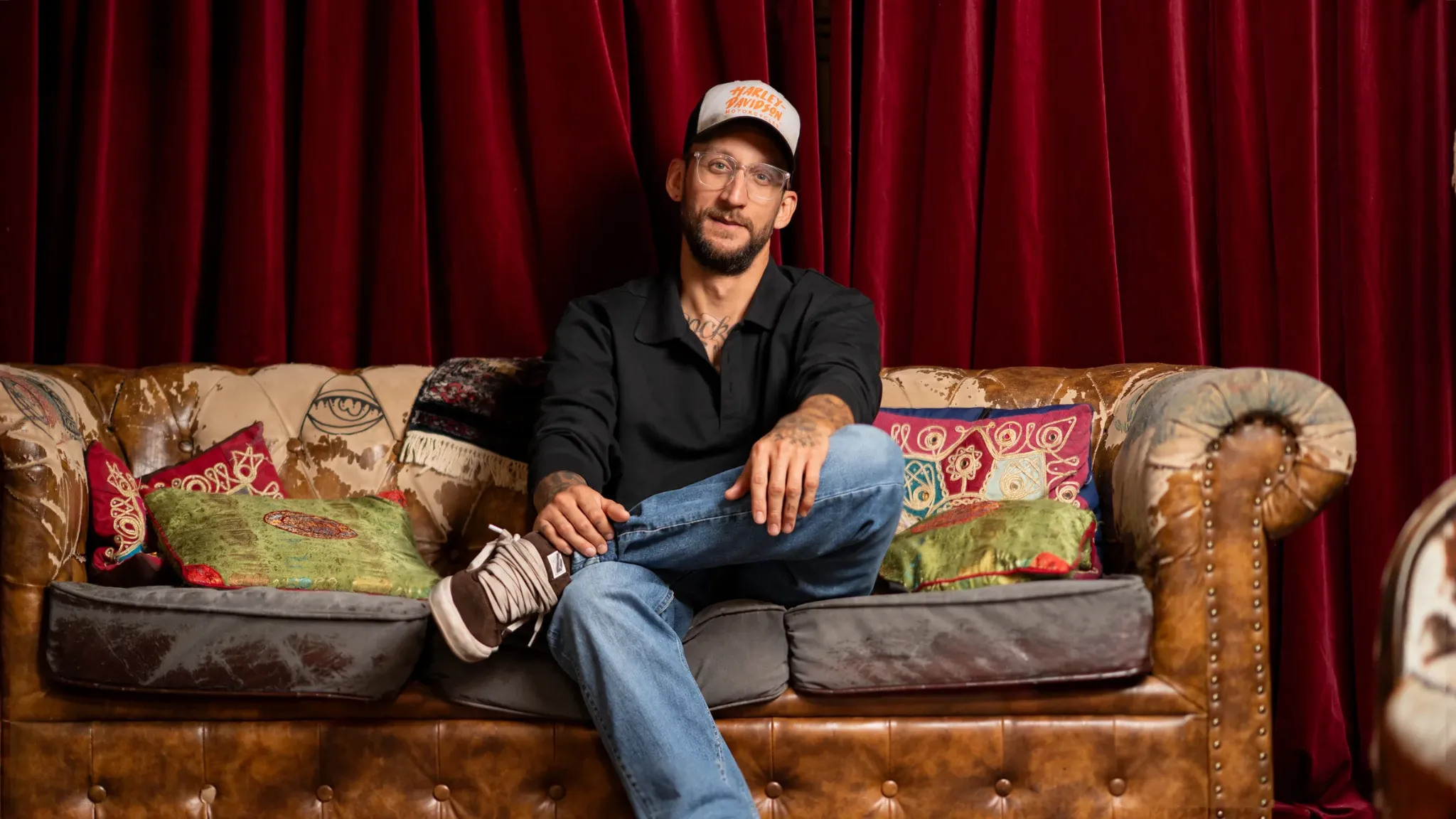 Stan Kuipers on a vintage sofa at Wickie Design at Sectie-C in Eindhoven.