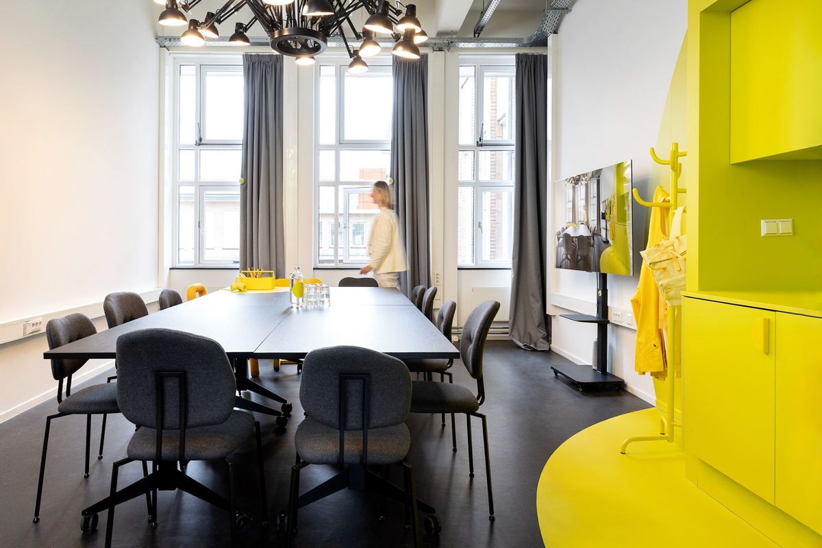 Meeting room with a long table and yellow accents